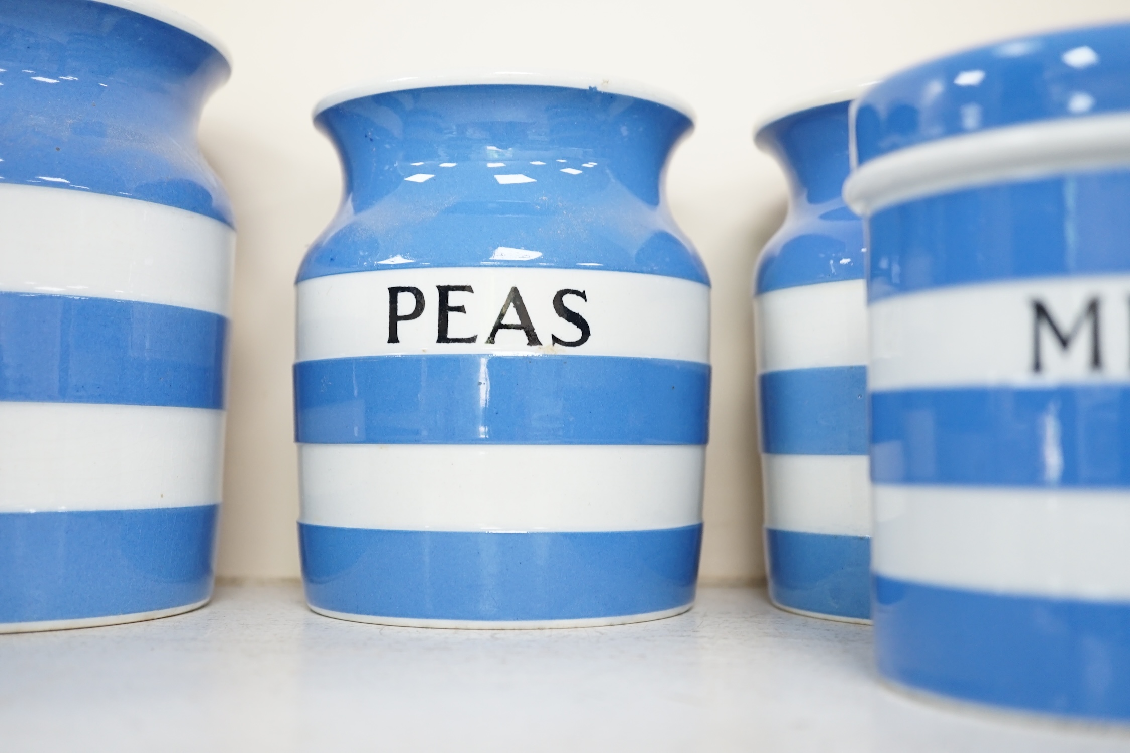 T.G.Green Cornish Kitchenware, fifteen lidded storage jars, to include Moist Sugar, Spaghetti, Semolina, Patna Rice, Brown Rice, Butter and Lard, largest 14cm high, Black Shield marks. Condition - poor, fair and good